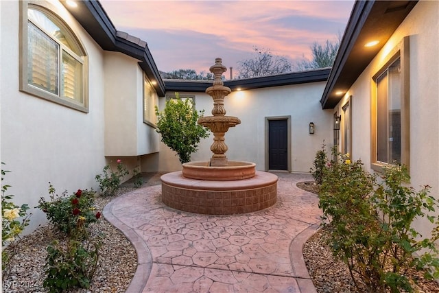 view of patio terrace at dusk