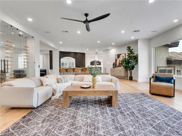 living room with ceiling fan and hardwood / wood-style floors