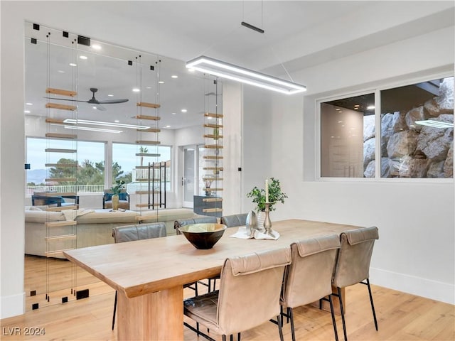 dining area featuring ceiling fan and light wood-type flooring