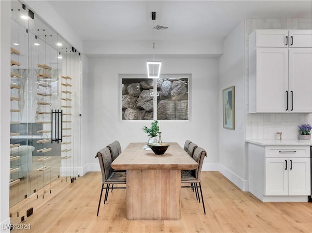 dining space featuring light wood-type flooring