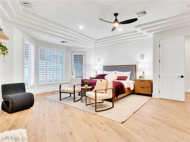 bedroom featuring ceiling fan, a raised ceiling, wood-type flooring, and wood ceiling