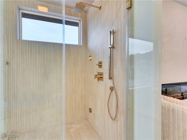 bathroom featuring a shower with shower door