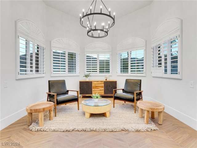 living area featuring parquet flooring and an inviting chandelier