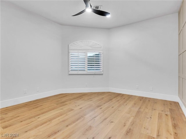 spare room with ceiling fan and light wood-type flooring