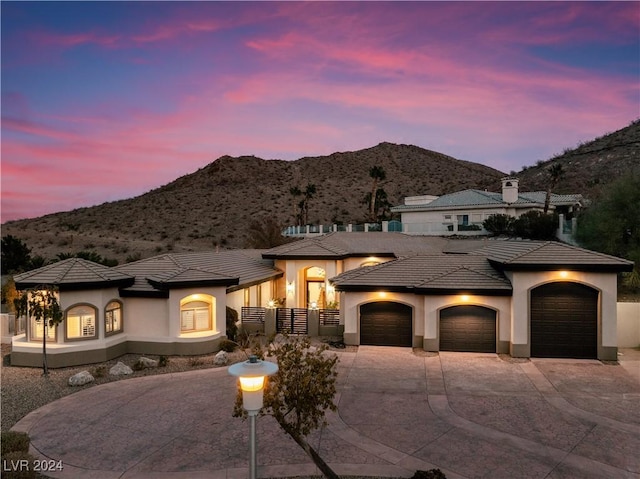 view of front of property with a mountain view and a garage