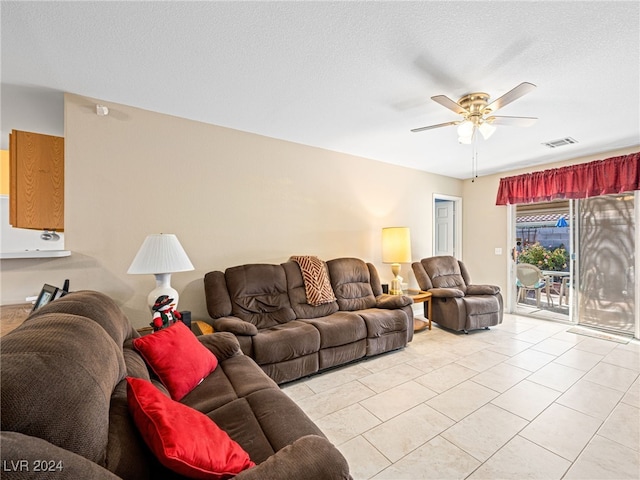 tiled living room featuring a textured ceiling and ceiling fan