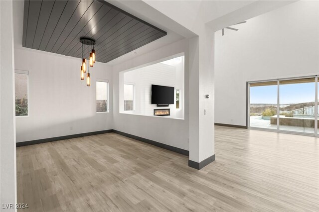 unfurnished living room with a fireplace and light hardwood / wood-style flooring