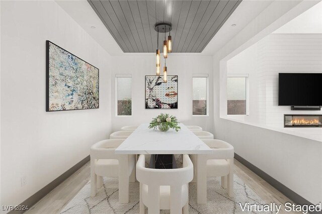 dining area with wooden ceiling and light wood-type flooring