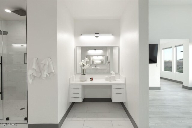 bathroom with vanity and a shower with shower door