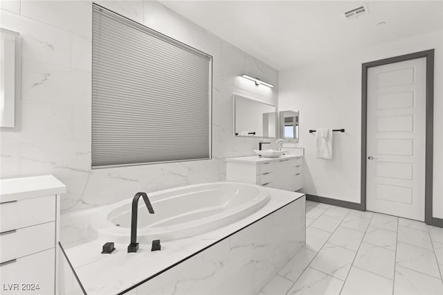 bathroom with tiled bath and vanity