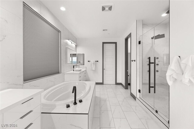 bathroom featuring vanity and plus walk in shower