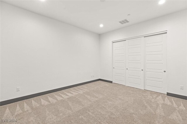 unfurnished bedroom with carpet and a closet