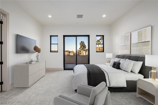 bedroom with access to exterior and light colored carpet