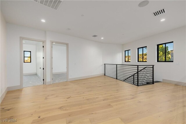 unfurnished room with light hardwood / wood-style floors