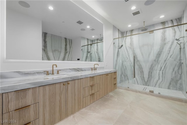 bathroom with vanity and a shower with shower door