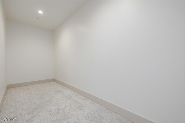 unfurnished room featuring light carpet