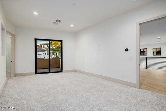 spare room with light colored carpet