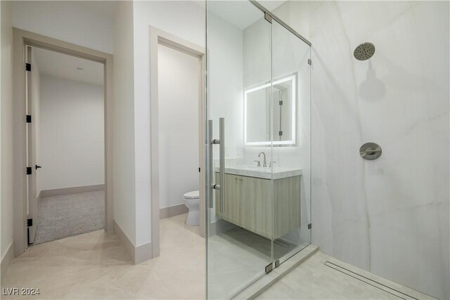 bathroom with vanity, toilet, and a shower