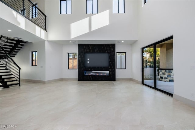 unfurnished living room with a high ceiling