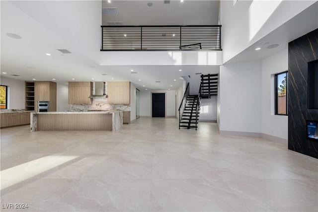 living room featuring a healthy amount of sunlight and a high ceiling