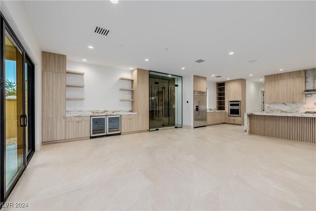 unfurnished living room featuring beverage cooler