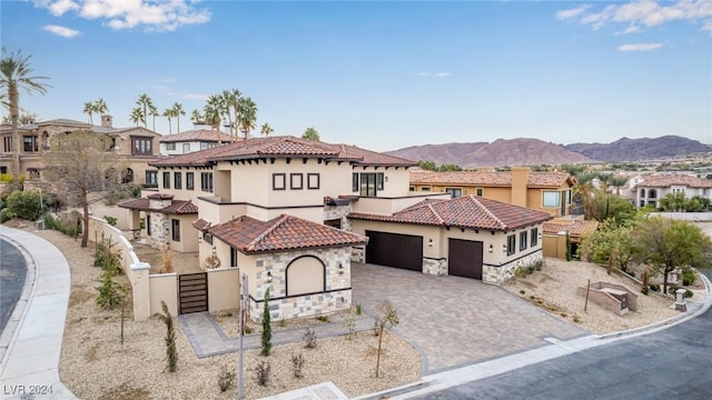 mediterranean / spanish-style house with a mountain view and a garage