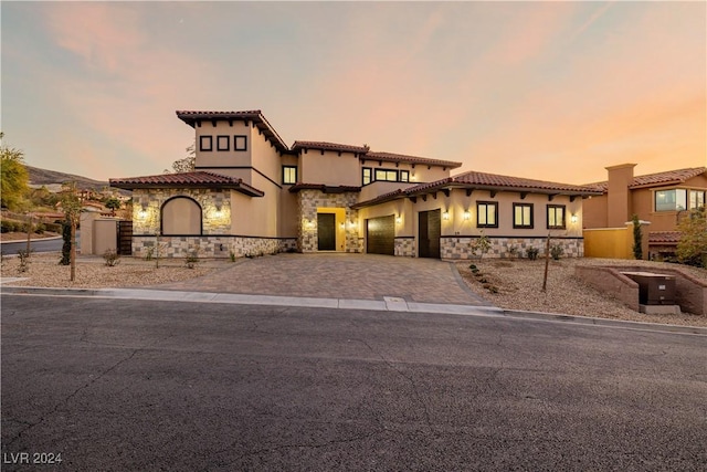 mediterranean / spanish house with a garage