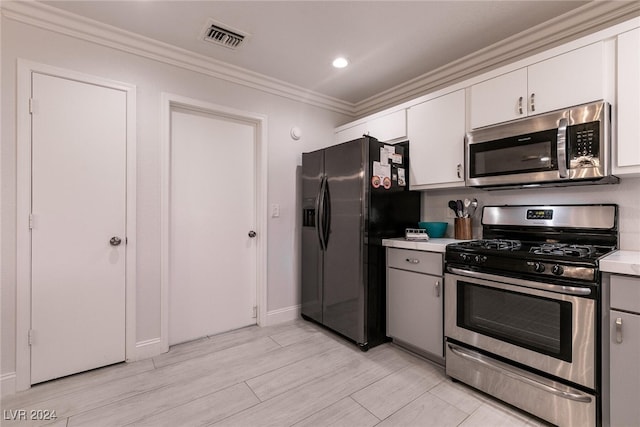 kitchen with white cabinets, visible vents, appliances with stainless steel finishes, and light countertops