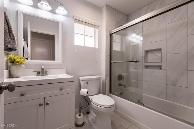 full bathroom featuring toilet, shower / bath combination with glass door, and vanity