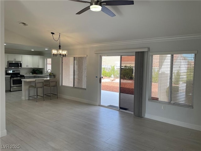 interior space with light wood finished floors, visible vents, ornamental molding, and baseboards