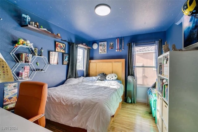 bedroom with light wood-type flooring