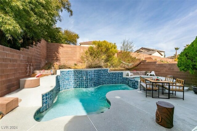 view of swimming pool featuring a patio area and pool water feature