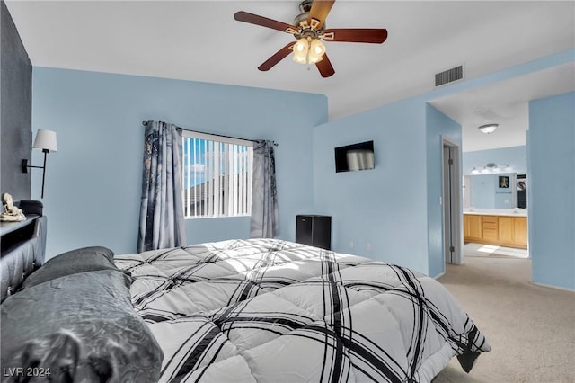 carpeted bedroom with ceiling fan and ensuite bathroom