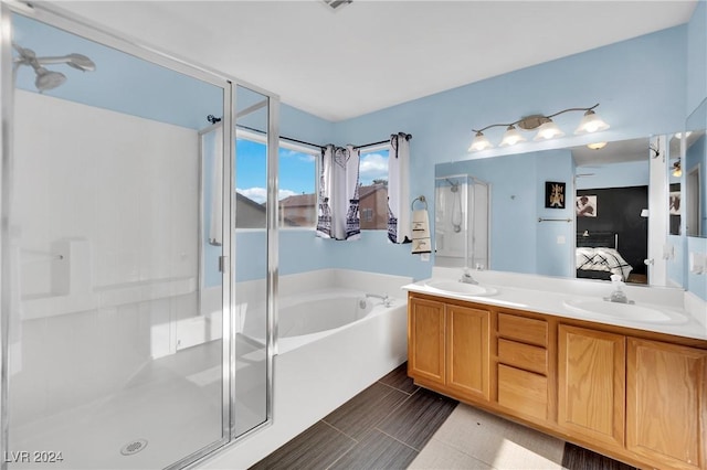 bathroom with tile patterned flooring, vanity, and separate shower and tub