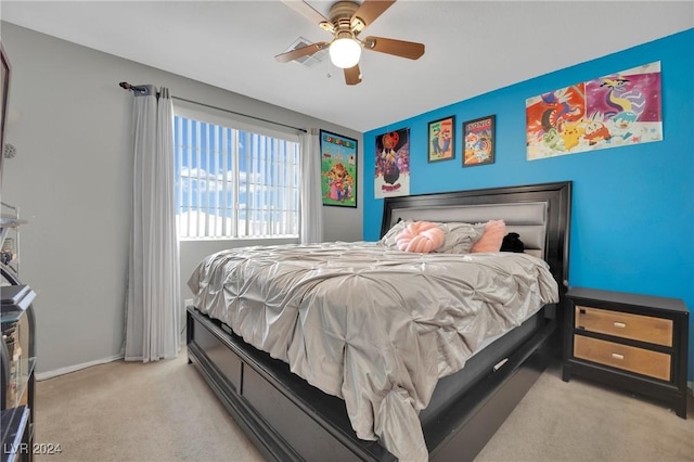 bedroom with ceiling fan and light carpet