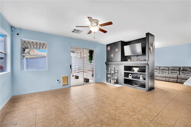 tiled living room featuring ceiling fan