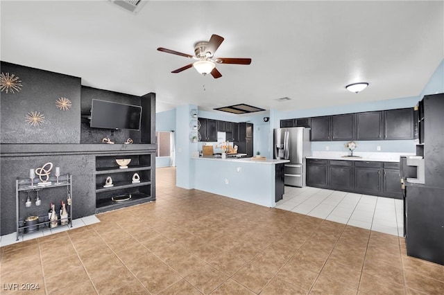 kitchen featuring kitchen peninsula, stainless steel fridge, light tile patterned floors, and ceiling fan