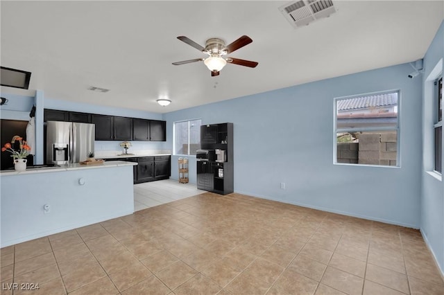 kitchen with ceiling fan, stainless steel fridge with ice dispenser, and light tile patterned floors