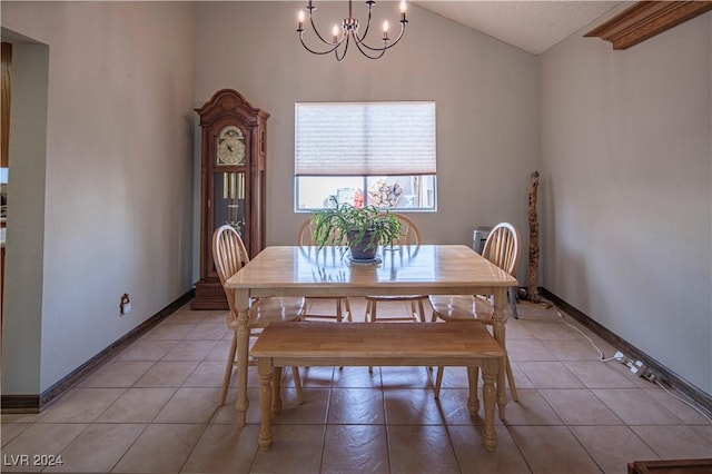 tiled dining space featuring an inviting chandelier and vaulted ceiling