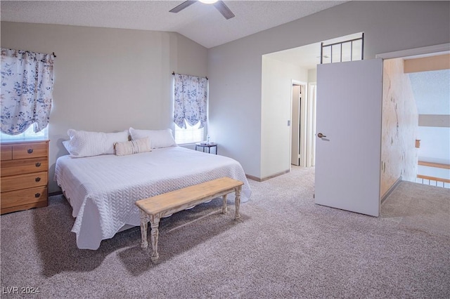 carpeted bedroom featuring a textured ceiling, ceiling fan, and vaulted ceiling