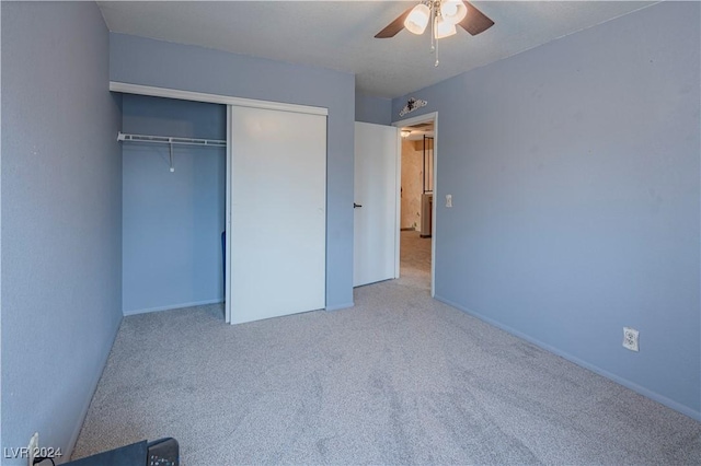 unfurnished bedroom with ceiling fan, a closet, and carpet floors