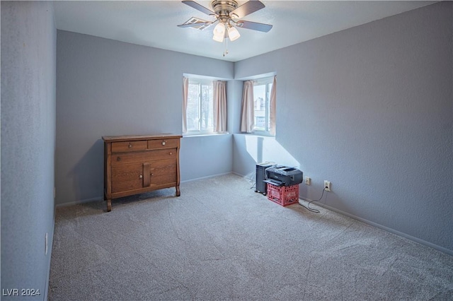 interior space with carpet floors and ceiling fan