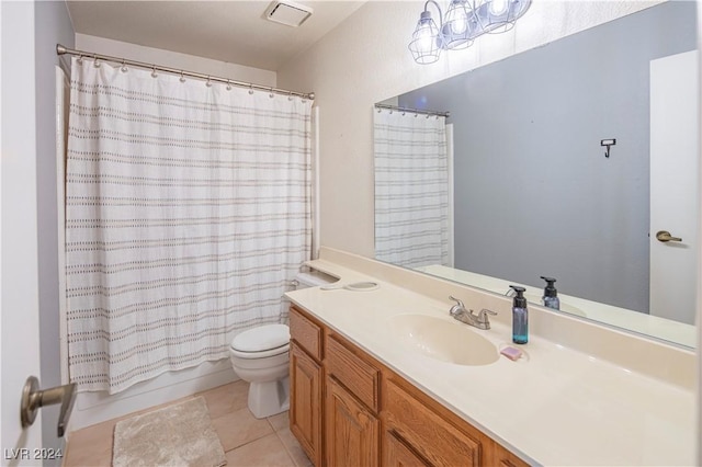 full bathroom featuring toilet, vanity, tile patterned floors, and shower / bath combo with shower curtain