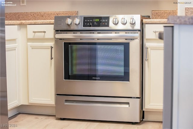 interior details featuring double wall oven and light countertops