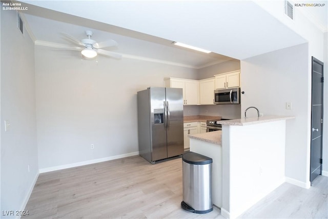 kitchen with light wood finished floors, light countertops, a peninsula, stainless steel appliances, and a ceiling fan