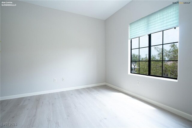 empty room with wood finished floors and baseboards