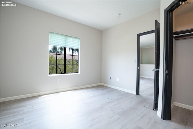 unfurnished bedroom featuring baseboards and light wood finished floors