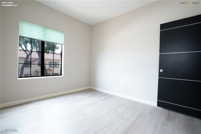 empty room featuring baseboards and wood finished floors