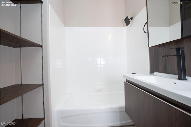 bathroom featuring shower / washtub combination and vanity