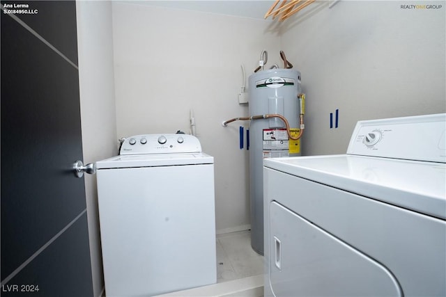 washroom featuring laundry area, independent washer and dryer, and water heater